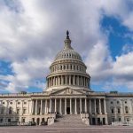 United States Capitol building under a partly cloudy sky