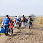 Europe ‘Catastrophe’ Warning Stuns Allies Group of people walking along a muddy farm road with bags and backpacks