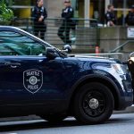Festival Chaos: 3 Dead, Toddler Hit, Killer Missing Seattle Police SUV parked on a city street