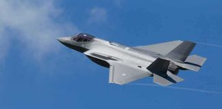 F-16 Fires Flares During Camp David Intercept Stealth fighter jet banking in a clear blue sky