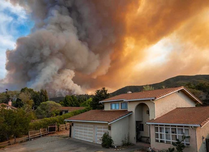 Suburban house under towering wildfire smoke plume
