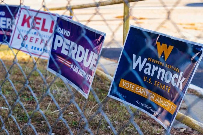 Campaign signs on a chain-link fence