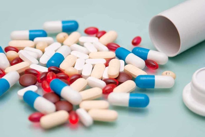 shutterstock_1925688692 Assorted pills and capsules spilled from a bottle