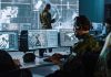 Military analysts at computers in a command center