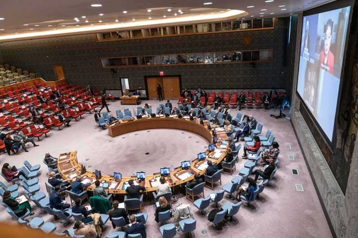 shutterstock_2060521844 Delegates seated around a circular conference table in a large chamber