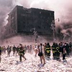 First responders amid debris near a heavily damaged building