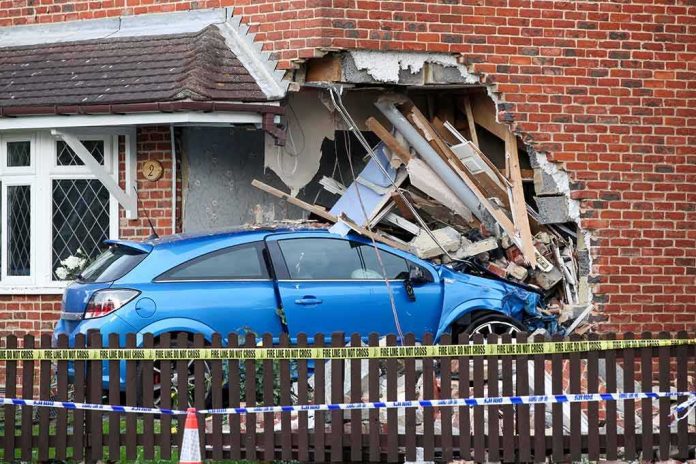 Blue car crashed into brick house wall