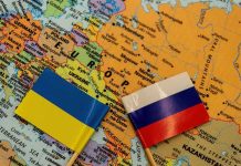 Ukraine and Russia flags on a map of Eastern Europe