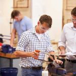 From Welders to Millionaires: SpaceX IPO Windfall Students using tools in a workshop with instructor supervising