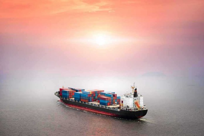 Container ship at sea under a hazy sunset
