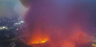Aerial view of large urban fire at night