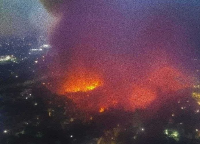shutterstock_2271023159 Aerial view of large urban fire at night
