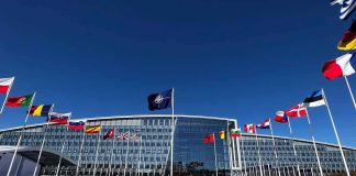 U.S. Base in Poland Nears Major Step NATO headquarters with member flags in front under a clear blue sky