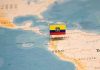 Mini flag pin marking Ecuador on a map of South America