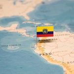 Mini flag pin marking Ecuador on a map of South America