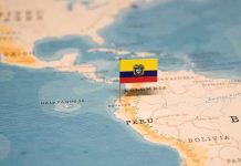 Mini flag pin marking Ecuador on a map of South America