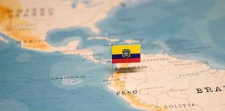 Mini flag pin marking Ecuador on a map of South America