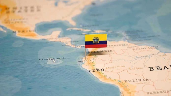 Mini flag pin marking Ecuador on a map of South America
