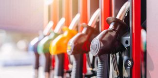 Close-up of fuel pump nozzles at a gas station