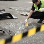Five Dead— Amazon Jet Slams Off Runway in Miami Forensic investigator marking evidence at crash scene