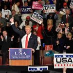 Trump Warns SC Voters: “Lose Everything” Donald Trump addresses a rally crowd at a podium, raising his fist