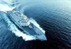 Naval warship cutting through open sea