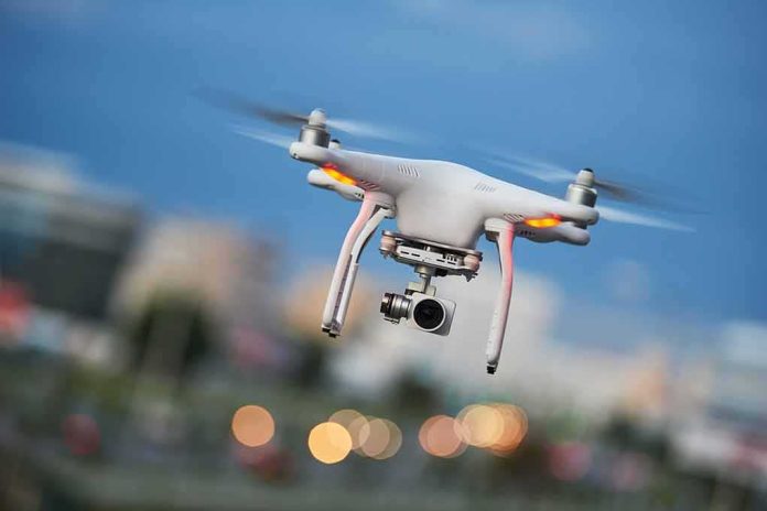 Quadcopter drone with camera flying outdoors