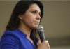 Tulsi Gabbard speaking into a handheld microphone
