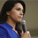 Tulsi Gabbard speaking into a handheld microphone