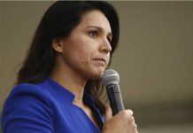 Tulsi Gabbard speaking into a handheld microphone
