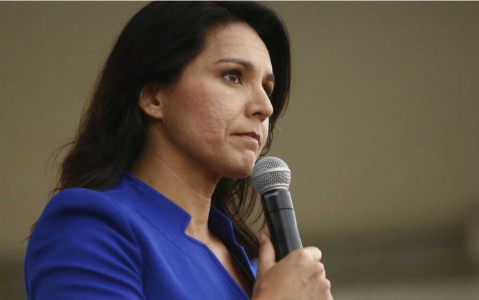 Tulsi Gabbard speaking into a handheld microphone
