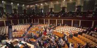 Alaska Stunner: Senator Picks Democrat Legislative chamber with members gathering on the floor