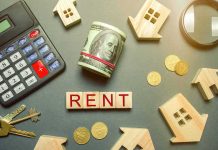 Rent payment concept with calculator, cash roll, coins, keys, and wooden house icons