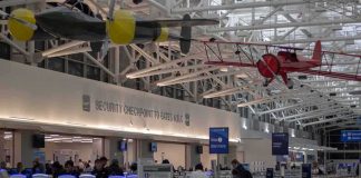 Deadly Riyadh Airport Strike Sends Travelers Fleeing airport security checkpoint with passengers and hanging vintage airplanes