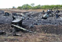 Airplane crash debris scattered across a burned field