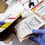 Toxicology Reveals Shared Substances Gloved hands handling labeled evidence bags and boxes