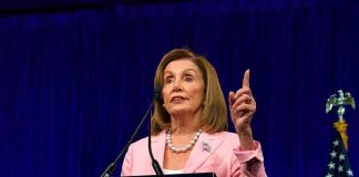 Democratic Divide Deepens Over Israel woman in pink blazer speaking at a podium