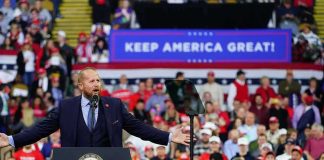 Trump Rallies Tennessee Republicans Crowd at a political rally with a speaker at a podium; Stephen Paea, Curtis Lofton, Walter Jones, John Sullivan, and Colin David Jones present