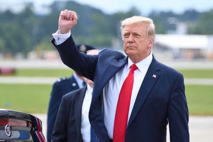 man in suit raising a clenched fist outdoors