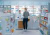 Yvonne Li assisting a customer at a pharmacy counter