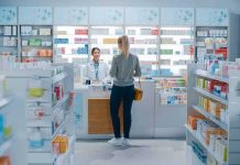 Yvonne Li assisting a customer at a pharmacy counter