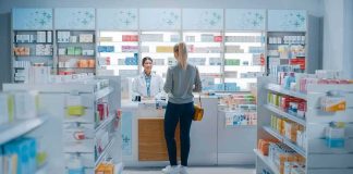Pharmacy Giant Slammed: CVS to Pay $315M in Opioid Case Yvonne Li assisting a customer at a pharmacy counter