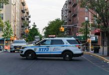 NYPD police SUV blocking a city street at a taped-off scene