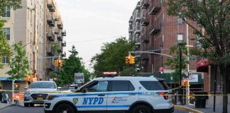 Officials Face Calls to Release Footage of ICE Shooting NYPD police SUV blocking a city street at a taped-off scene
