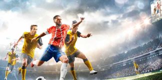 Soccer player in red jersey sprints past defenders in a stadium