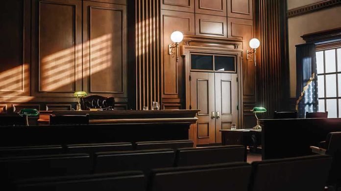 Empty courtroom interior with wooden judge's bench and double doors