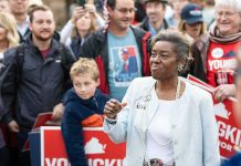 Woman addressing a crowd at an outdoor event
