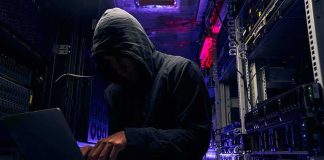 California Student Data Breach Exposes Millions of Records Hooded person using a laptop in a dark server room