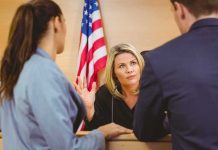 Judge speaking with two attorneys at the bench in a courtroom