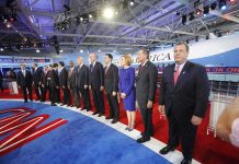 Chris Christie stands at right as Carly Fiorina, Jeb Bush, Ben Carson, and John Kasich line up on a debate stage
